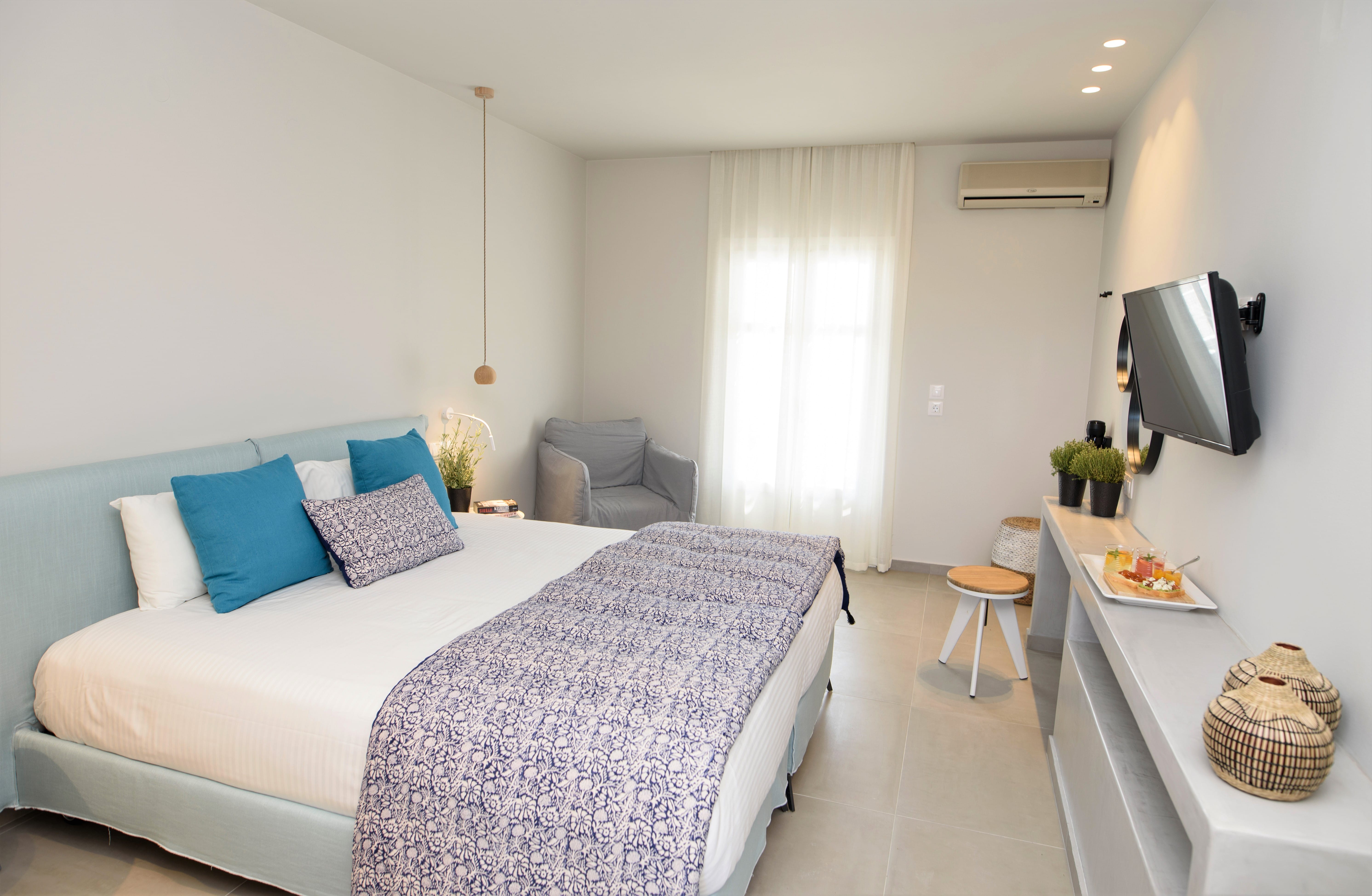 a bedroom with a bed and a tv