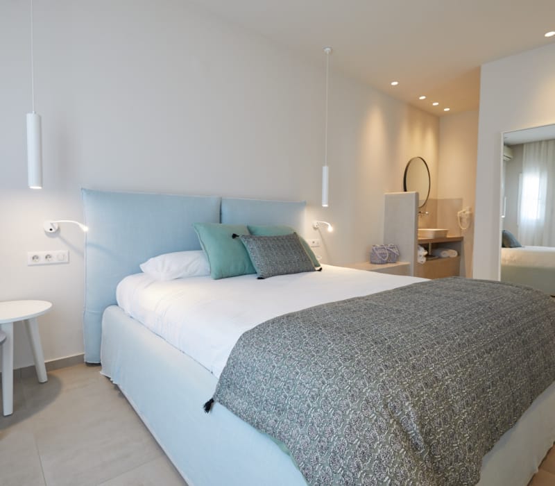 a hotel room with a bed and a desk