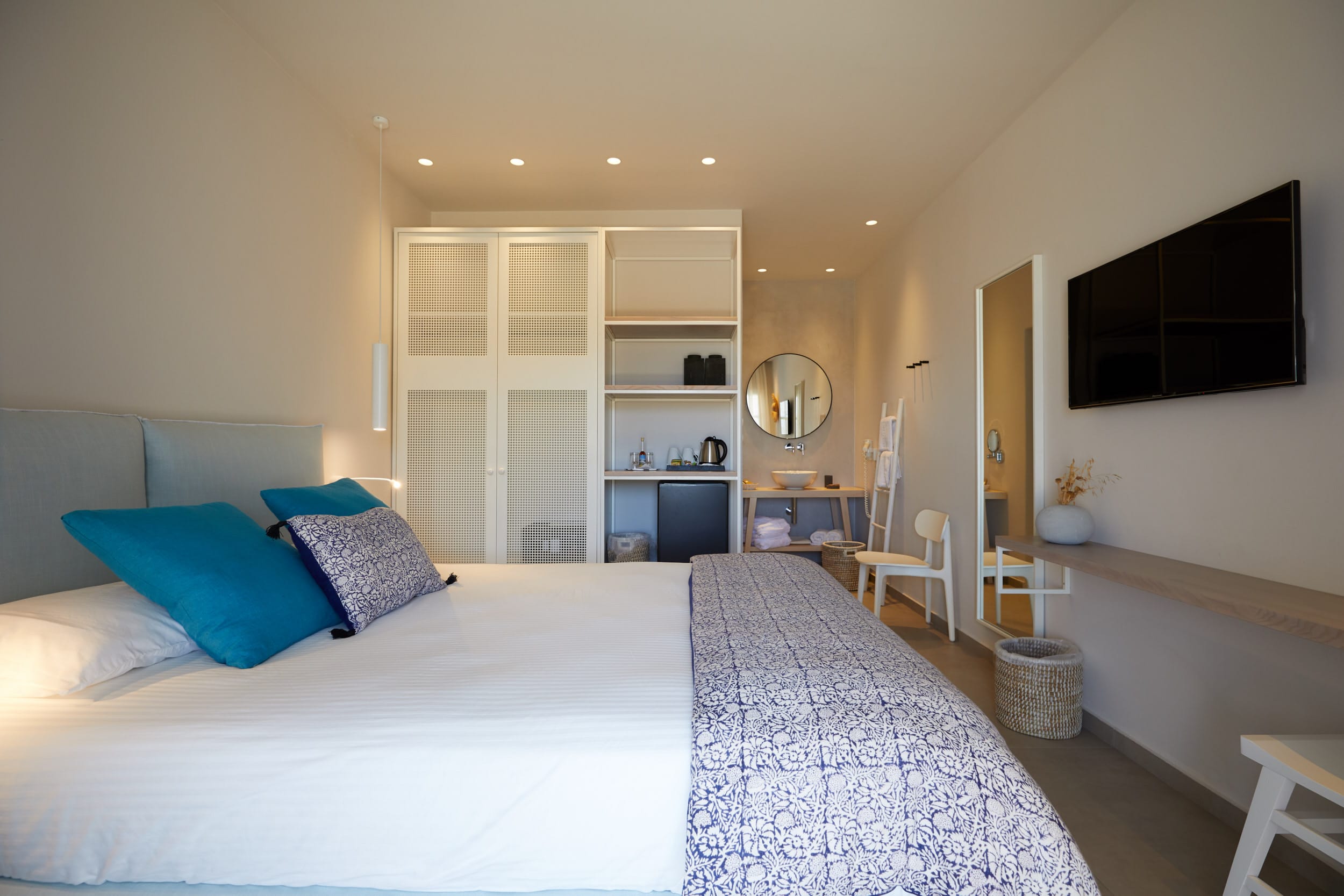 a bedroom with a bed and a tv