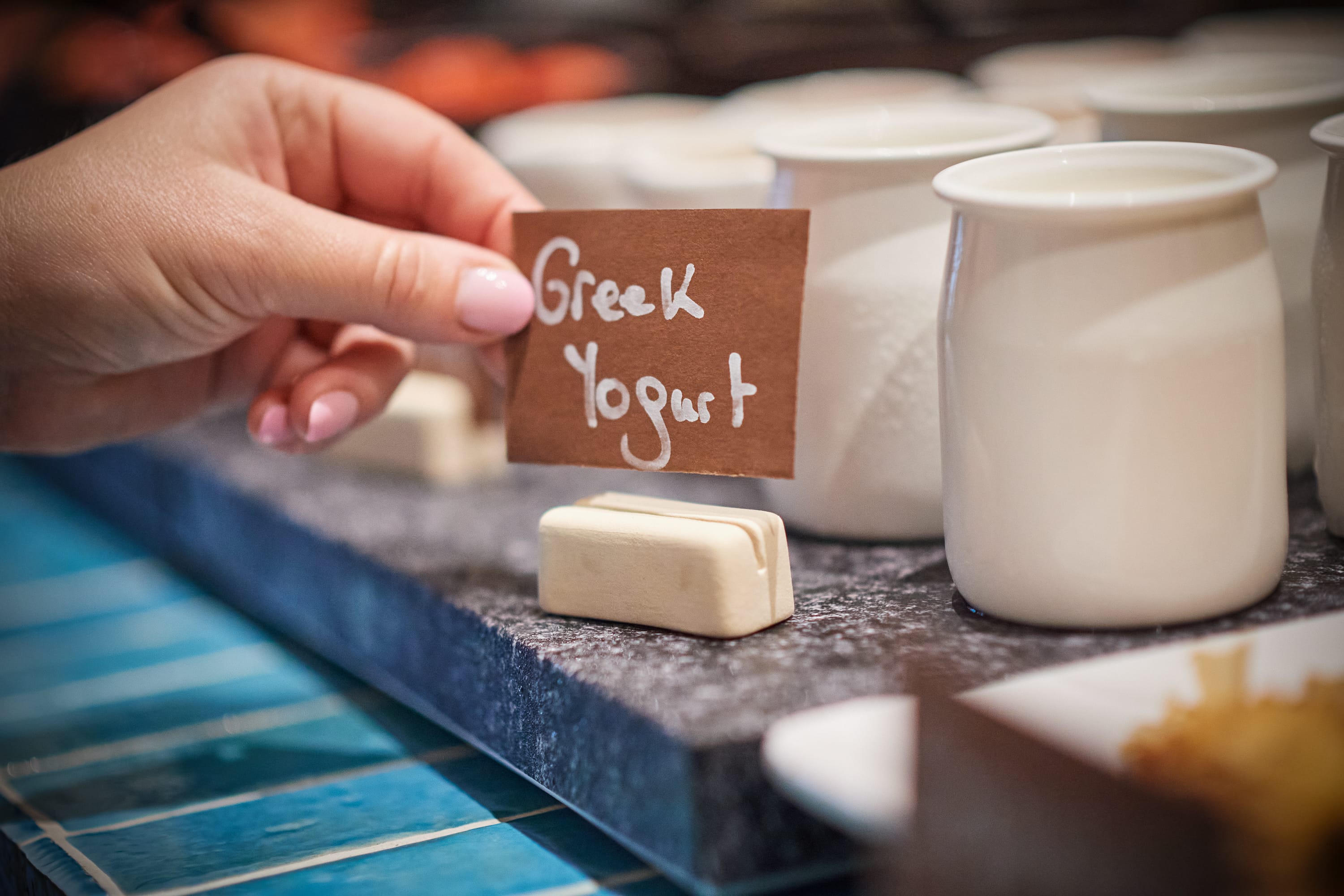 a hand holding a sign with a label