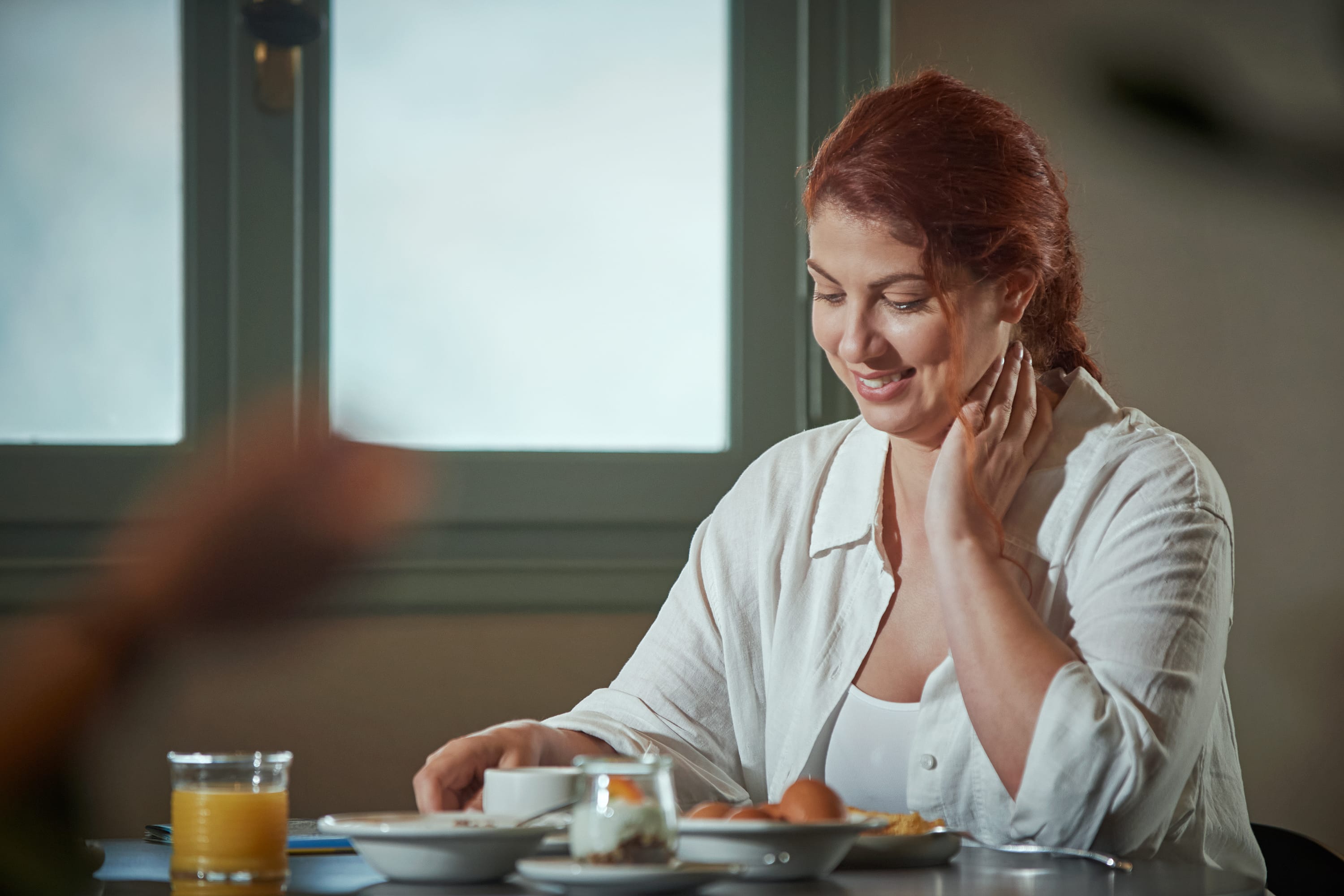 a person sitting at a table with food