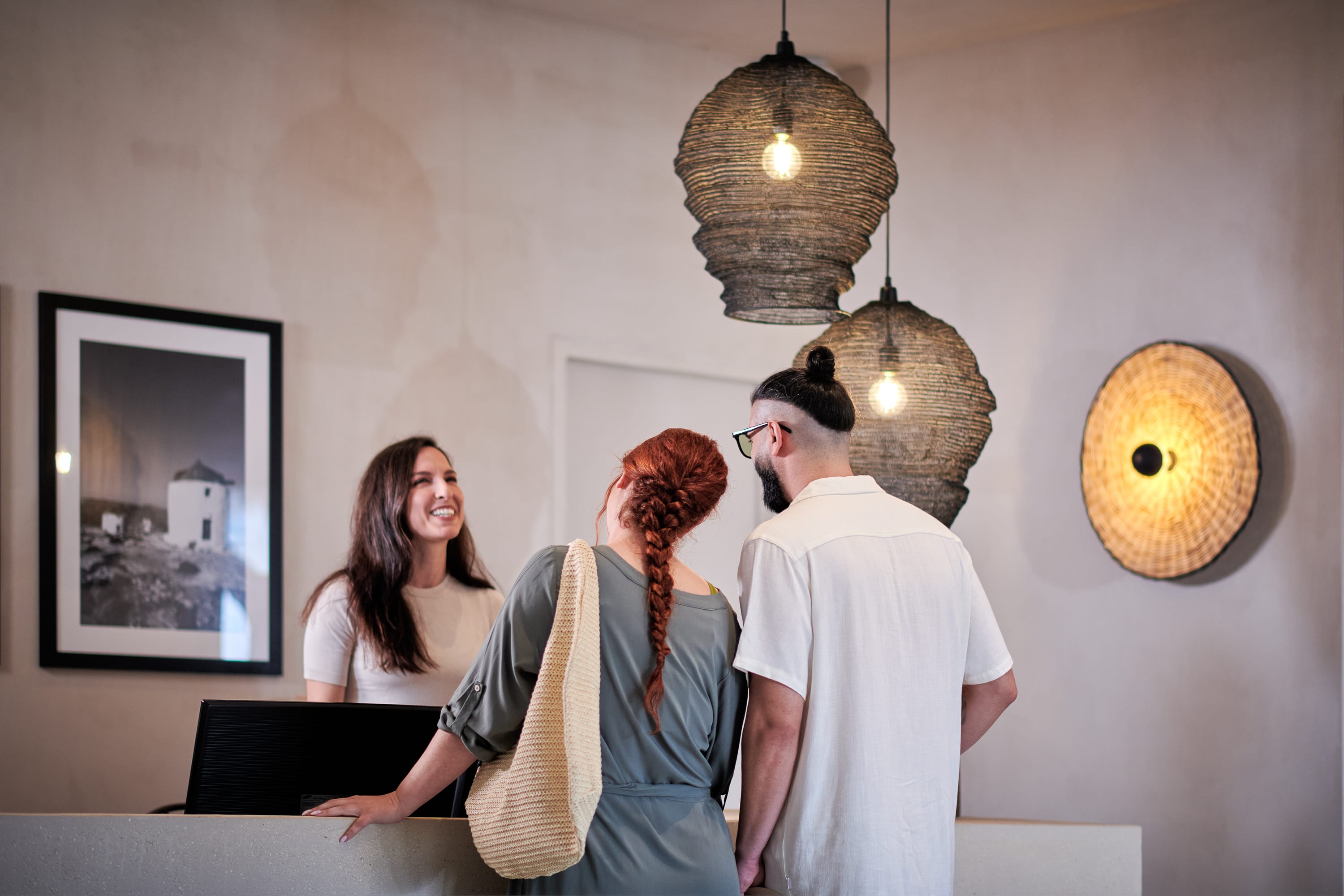 a group of people standing at a reception desk