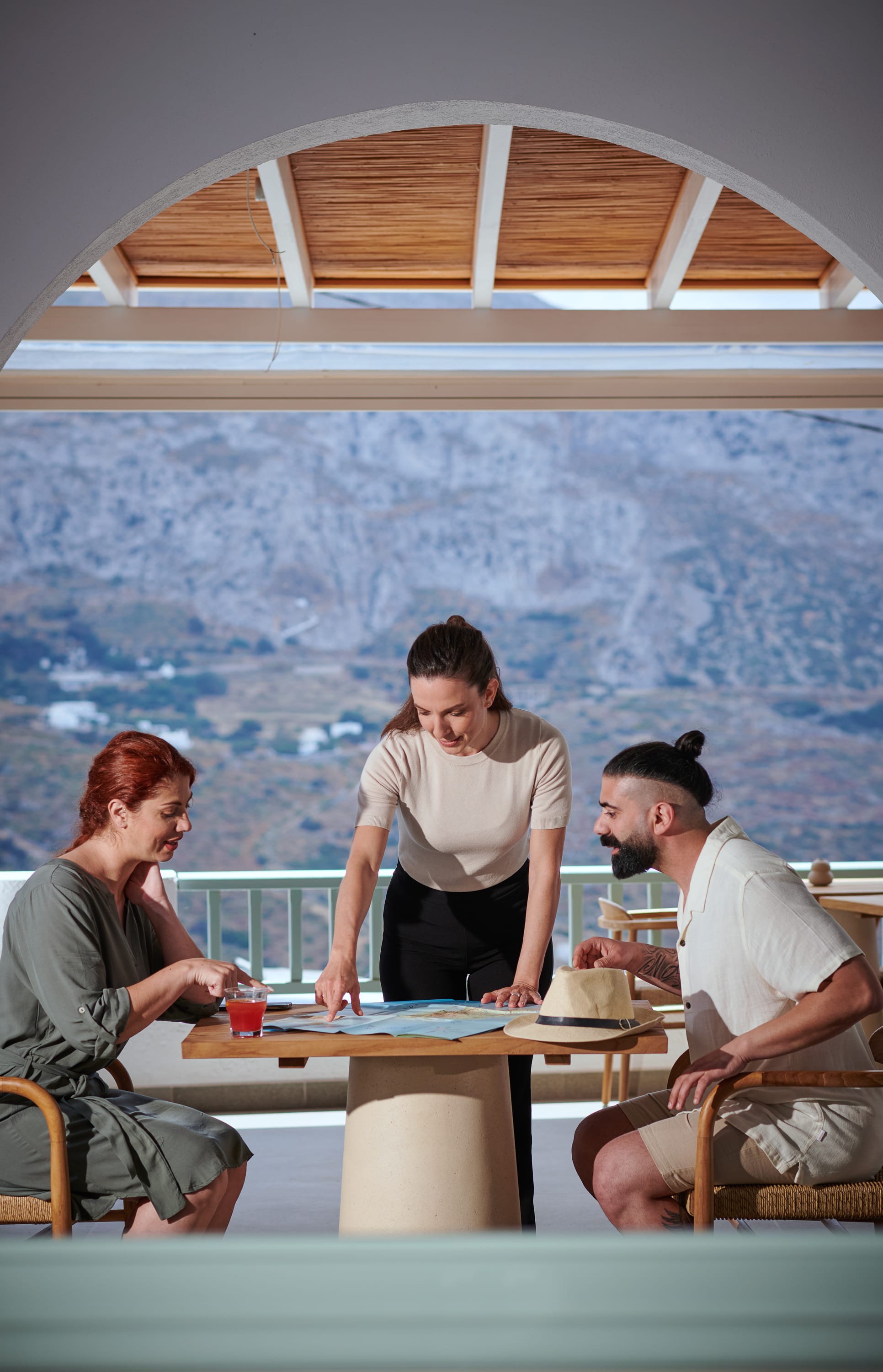 a person standing at a table with people around it