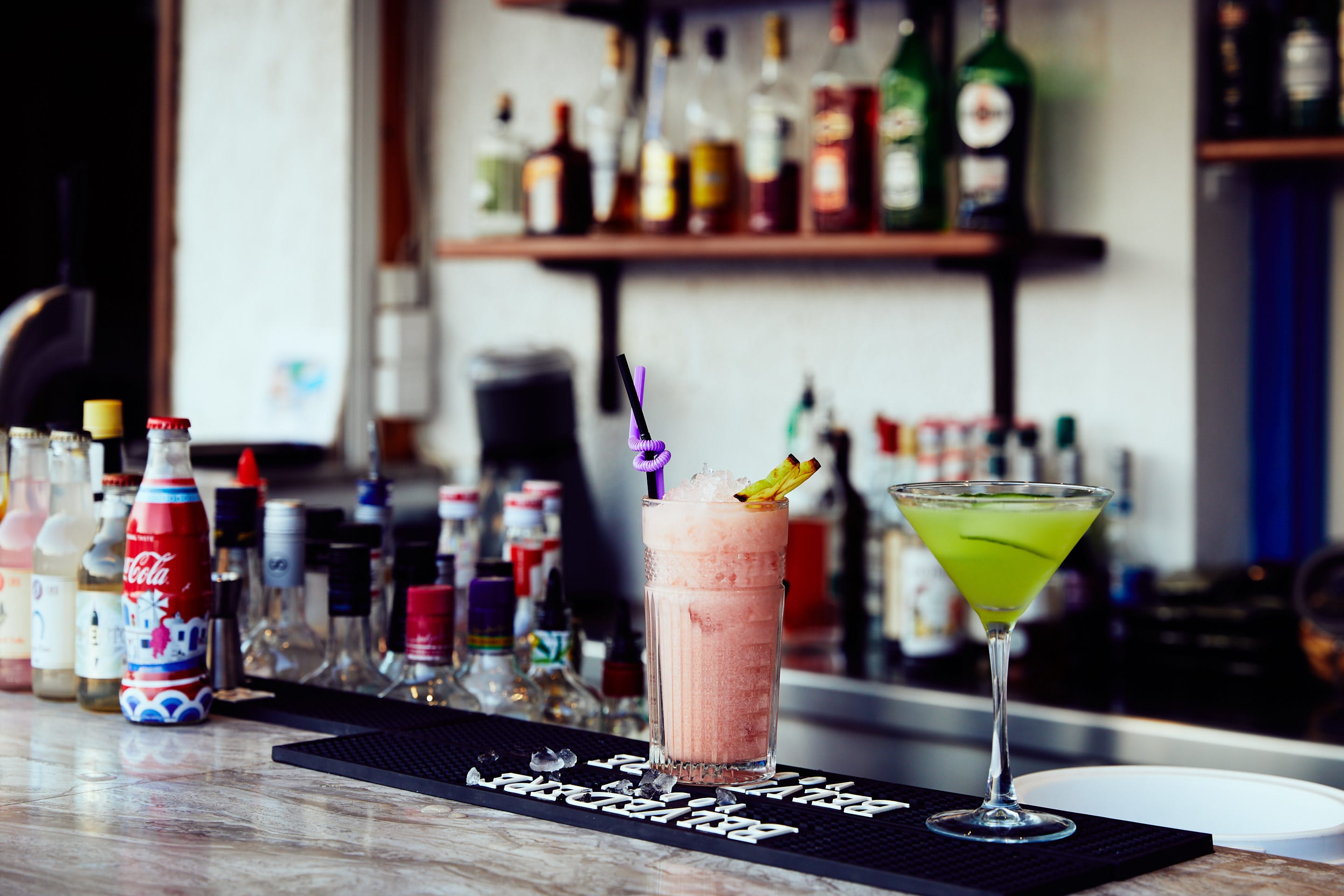 a glass of liquid on a bar