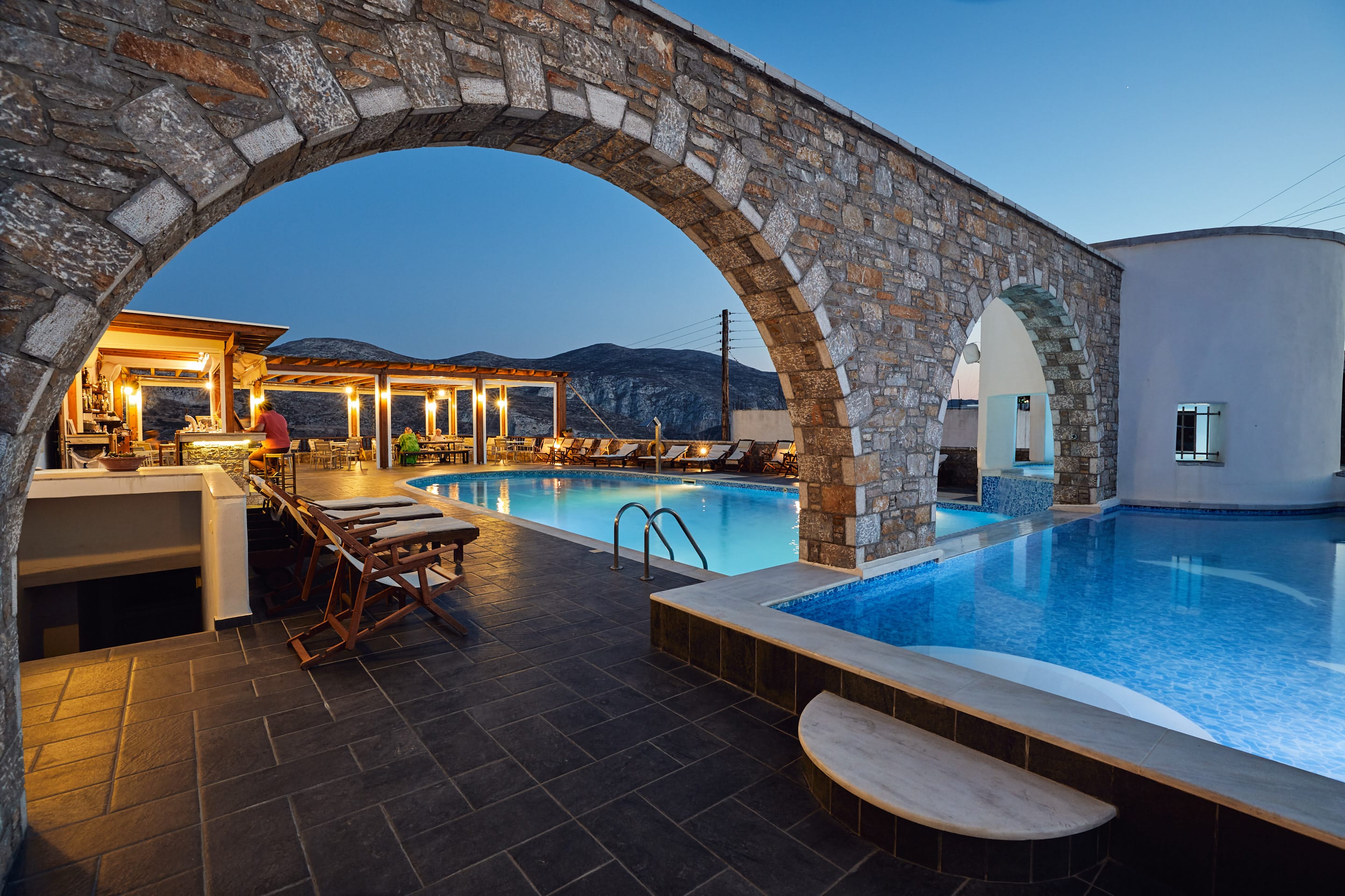 a pool with a stone patio
