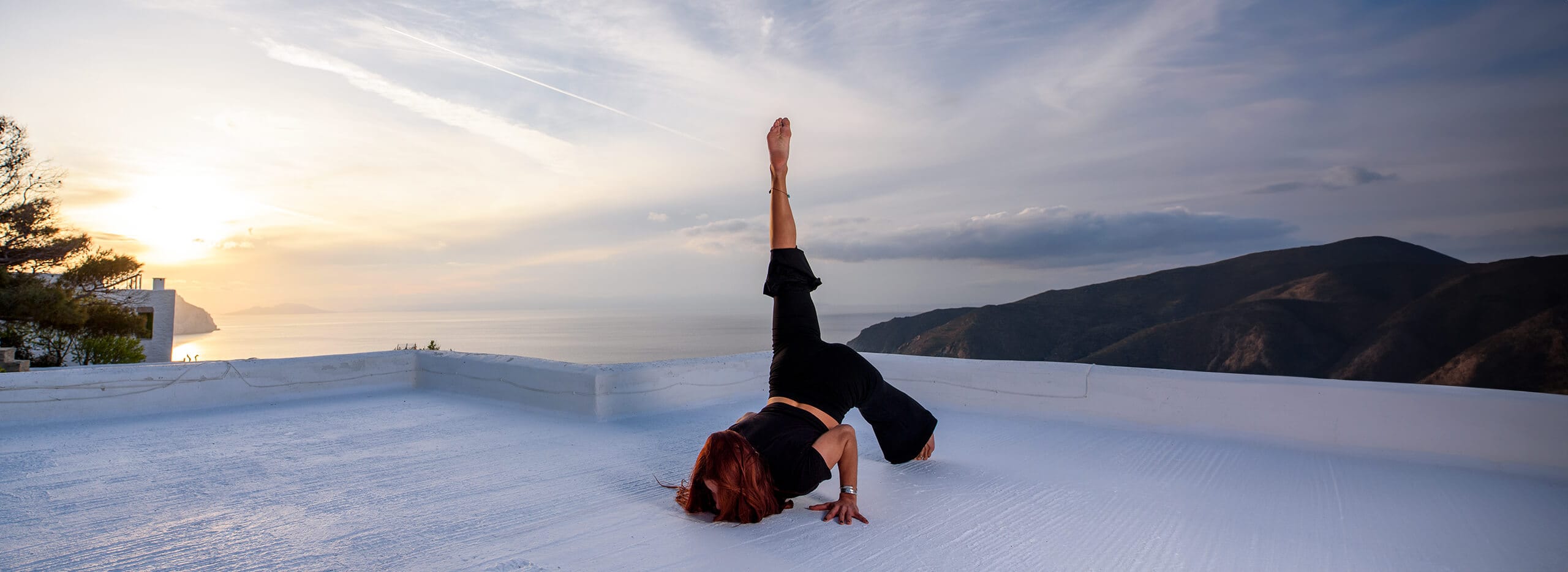 a man doing a handstand in the snow