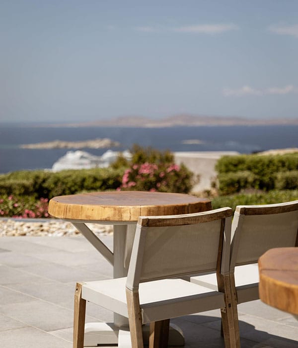 a table and chairs on a balcony overlooking a city