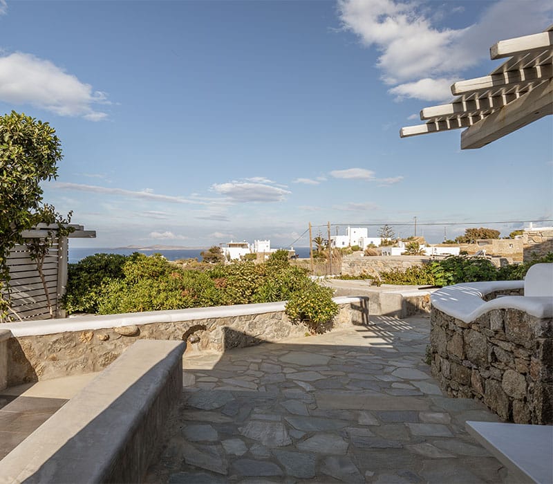 a stone walkway with a city in the background