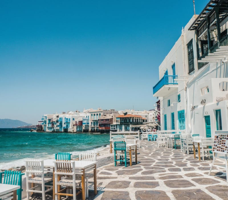 a row of buildings next to a body of water