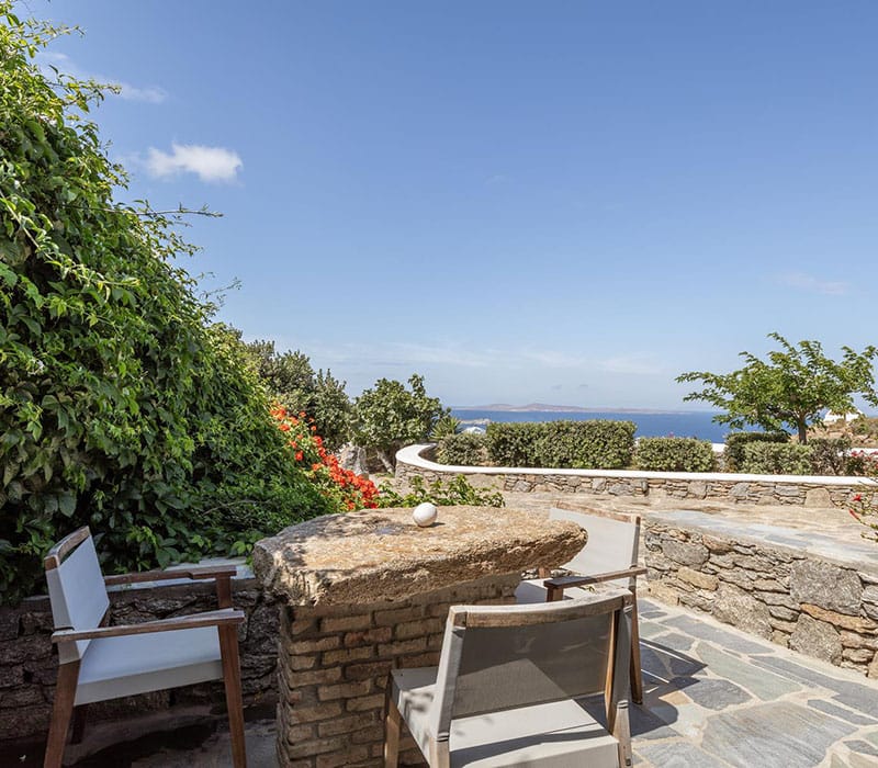 a patio with chairs and a table