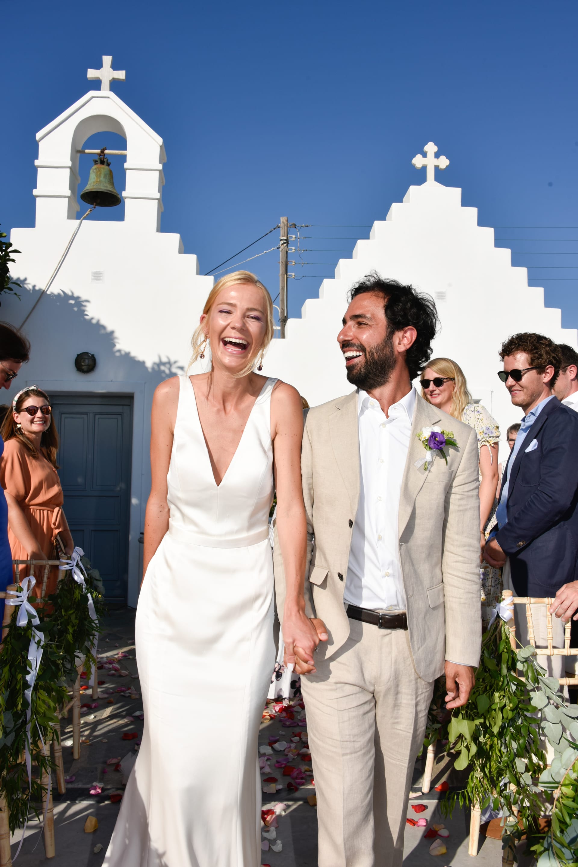 a man and woman posing for a picture in front of a church