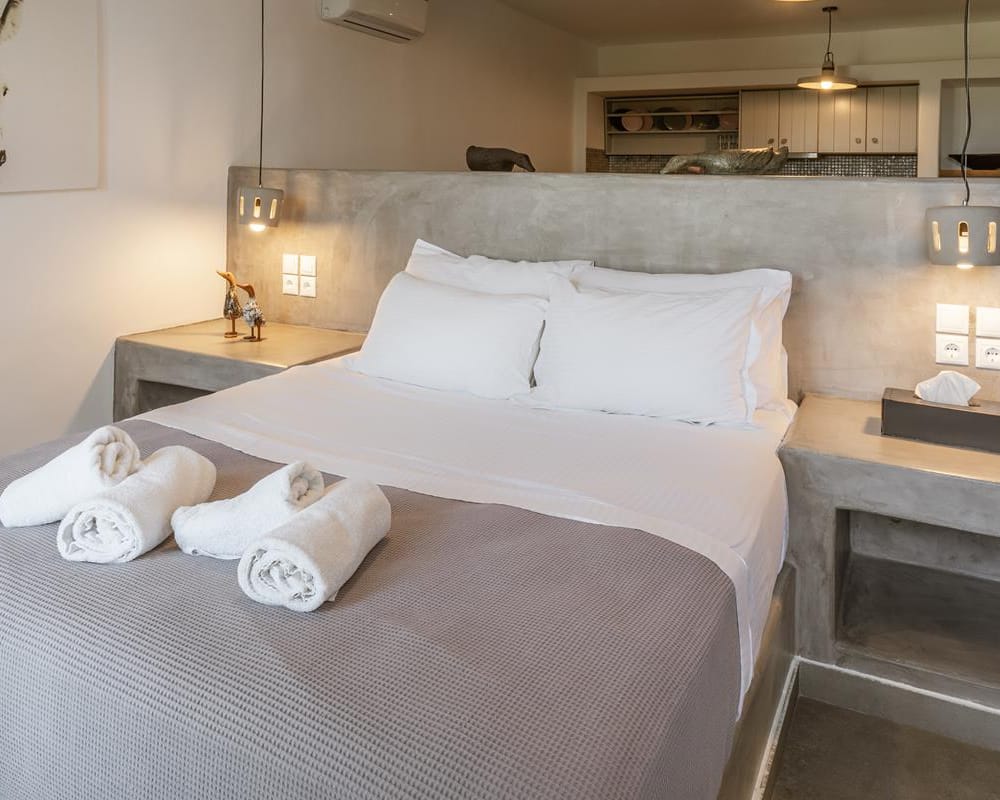 a large bed with white sheets