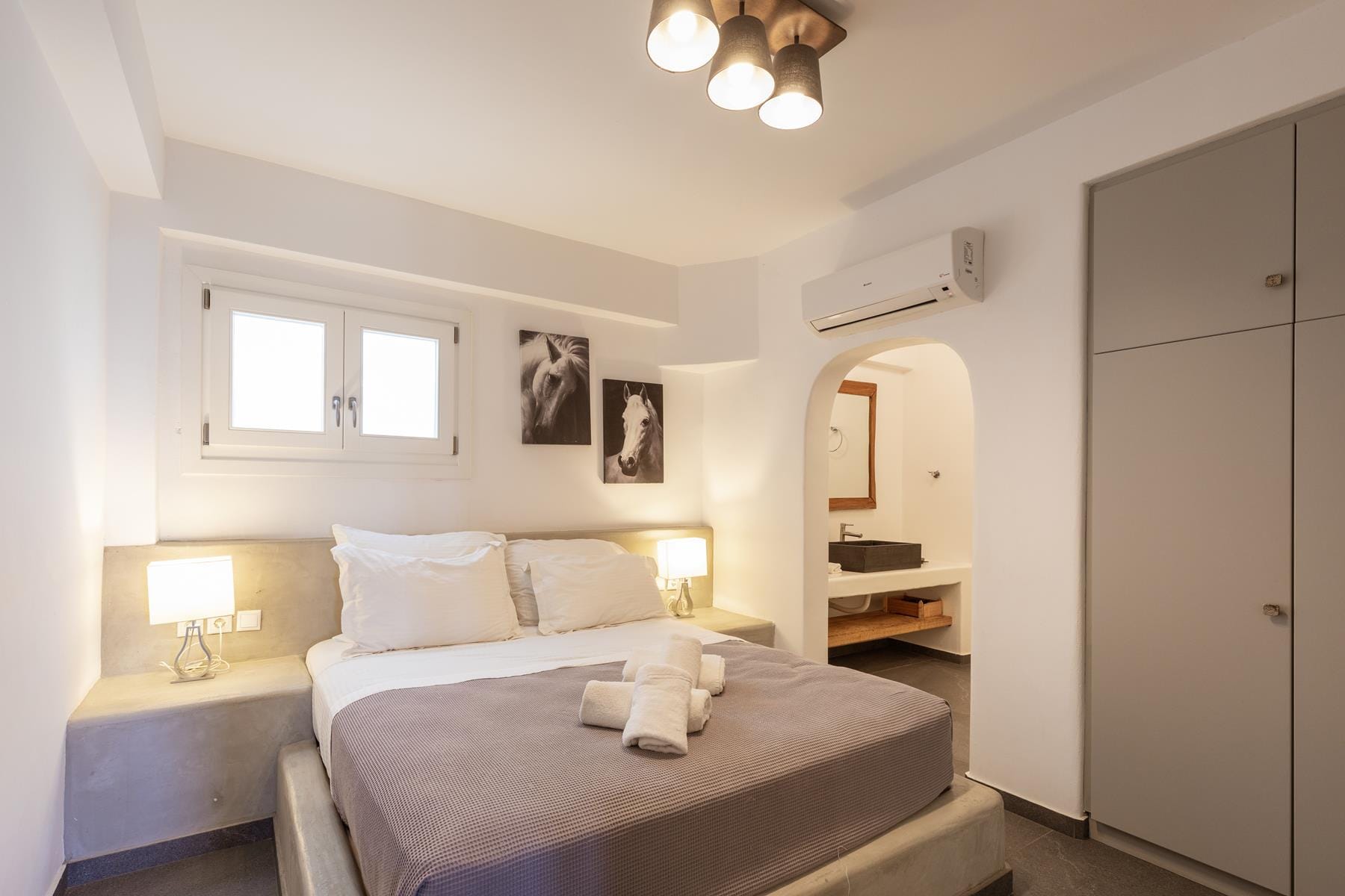 a bedroom with a bed and a mirror