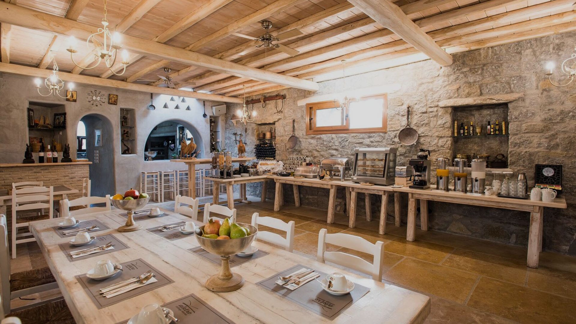 a large kitchen with a stone wall
