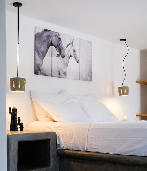 a bed with a painting on the wall