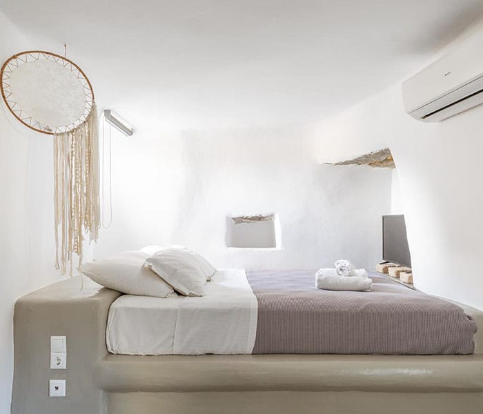 a bed with a mirror above it