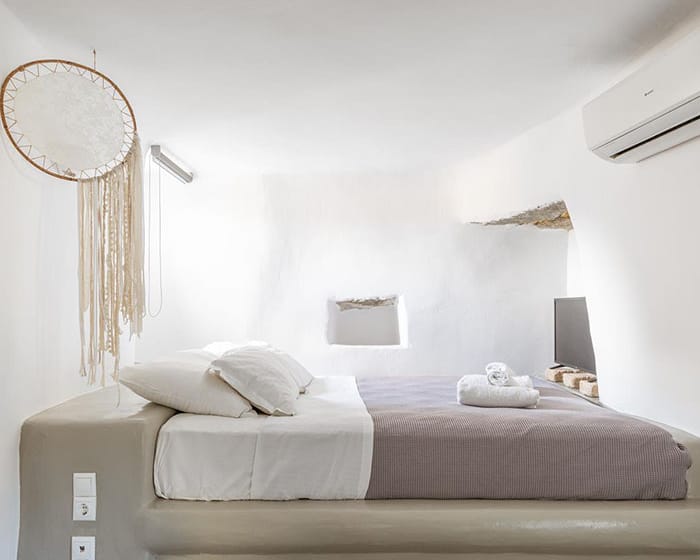 a bed with a mirror above it