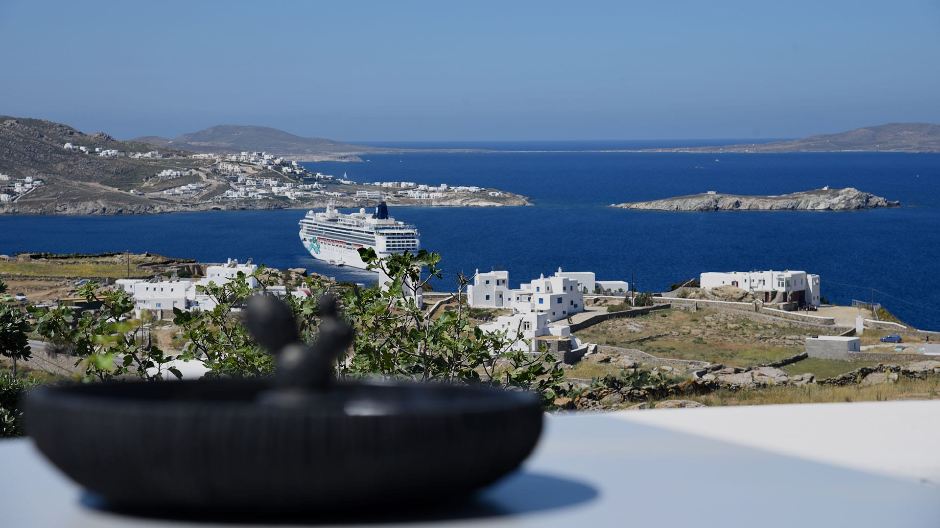 a view of a town and the ocean from a high elevation
