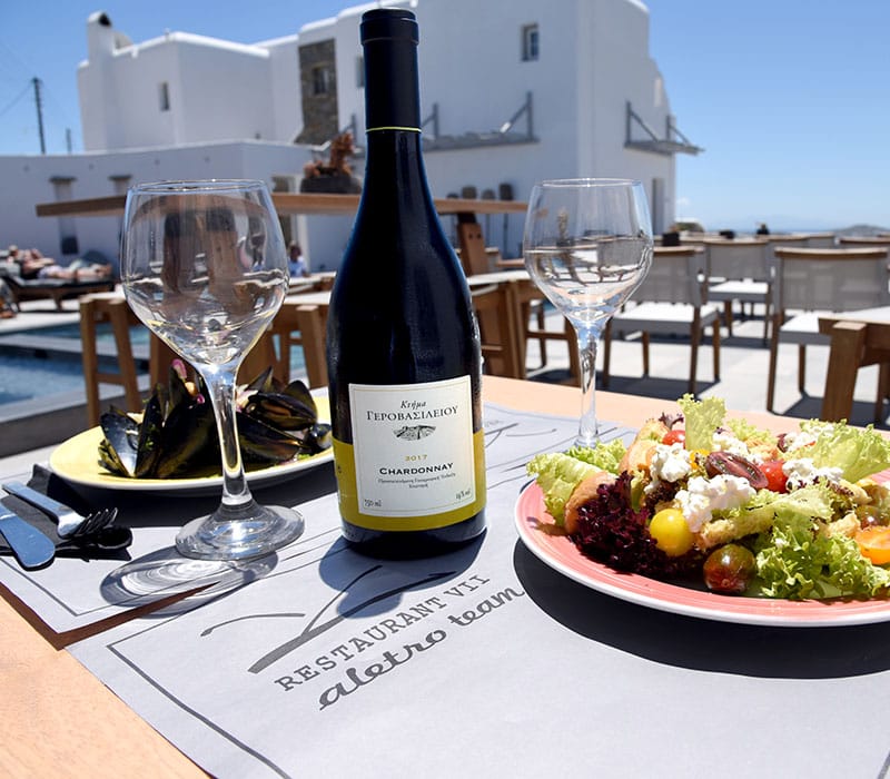 a wine bottle and glasses on a table