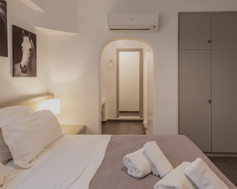 a room with white beds