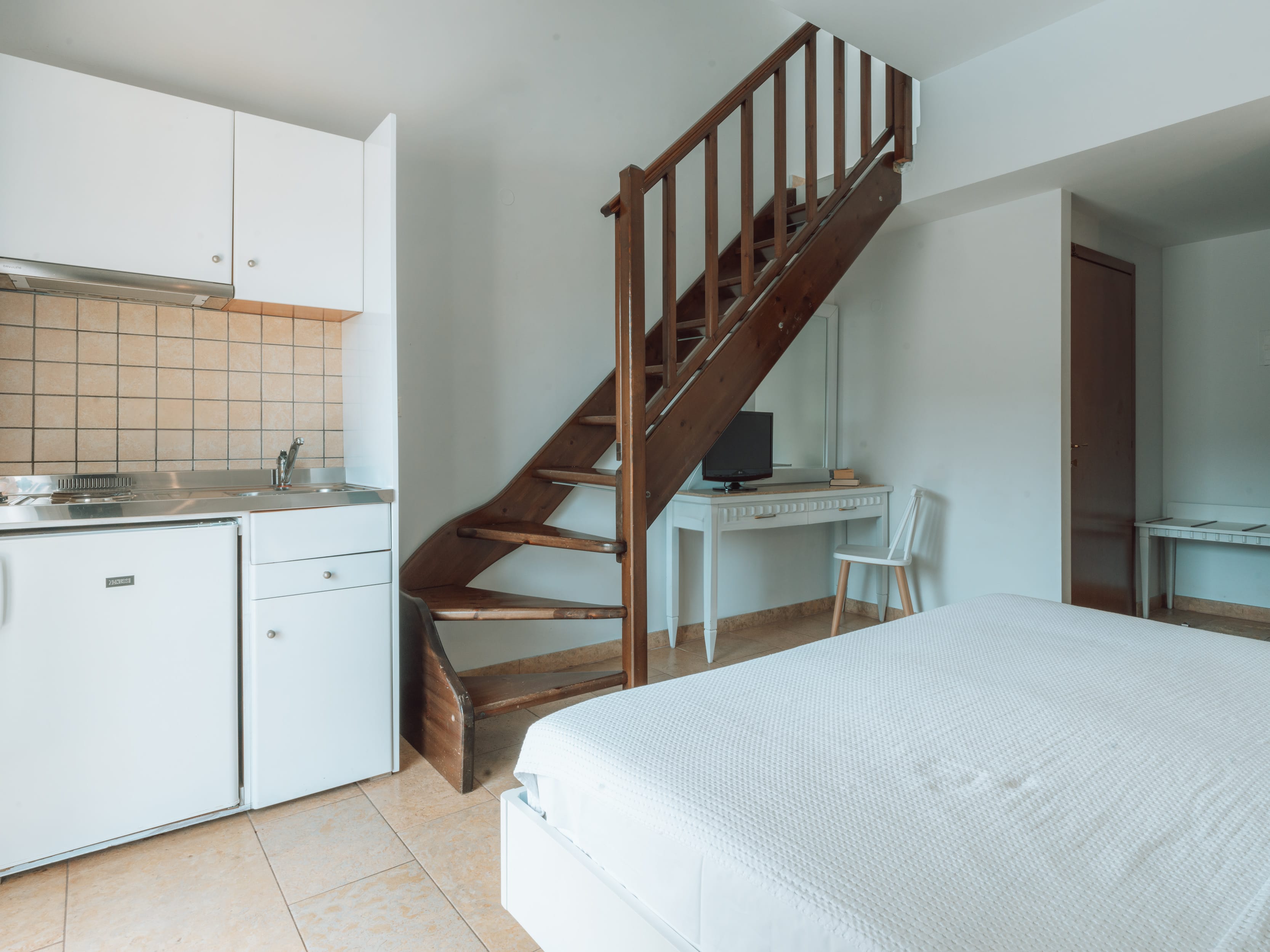 a kitchen with a staircase
