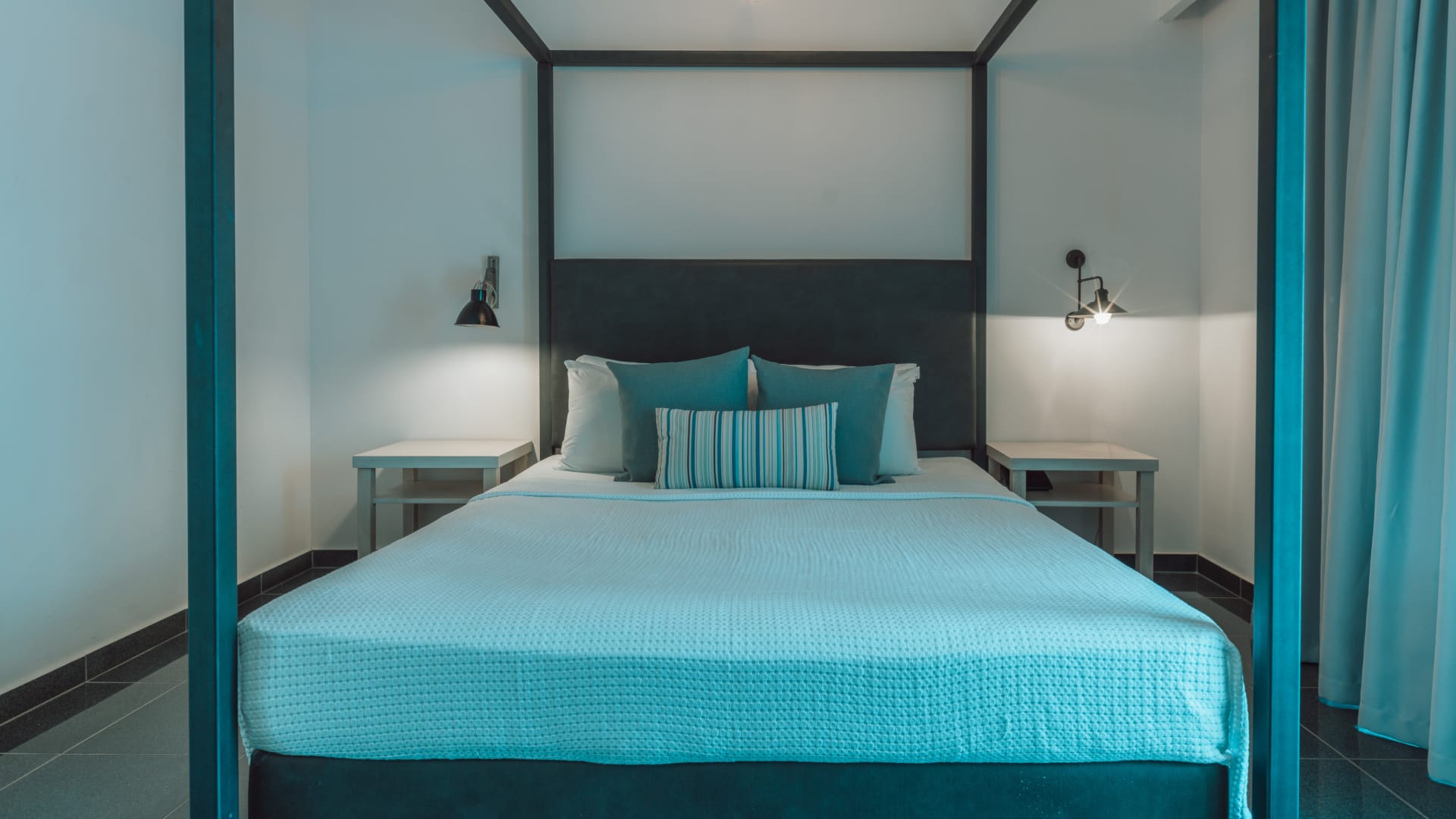 a bed with blue and white pillows