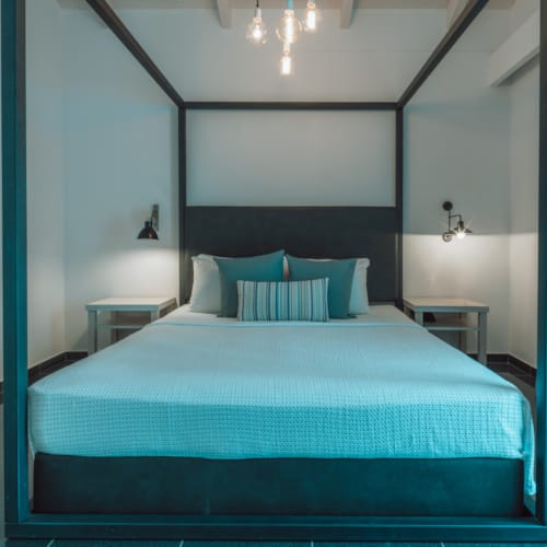a bed with blue and white pillows