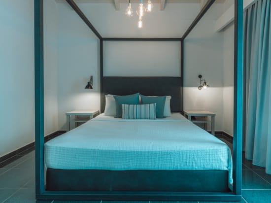 a bed with blue and white pillows