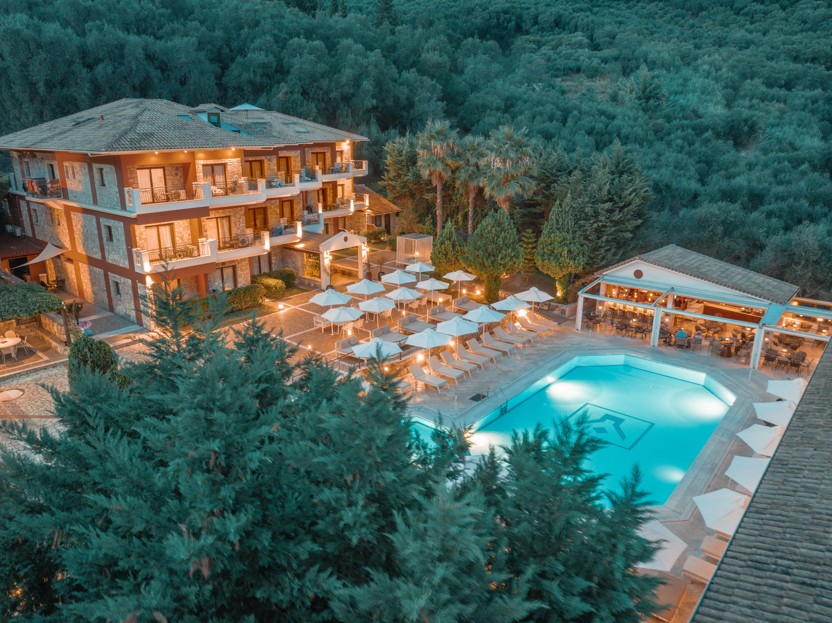 a house with a pool and trees around it