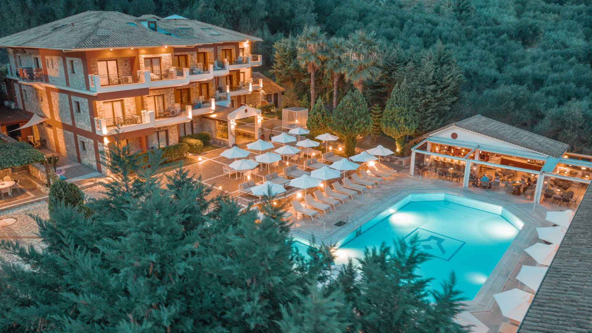 a house with a pool and trees around it