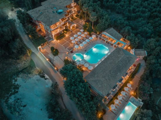 a building with a pool and trees around it