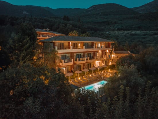 a house with a pool in the front surrounded by trees