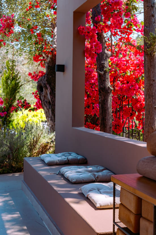a bench with pillows on it outside