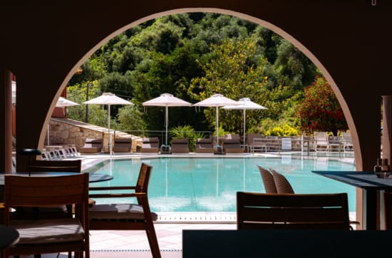 a pool with chairs and umbrellas