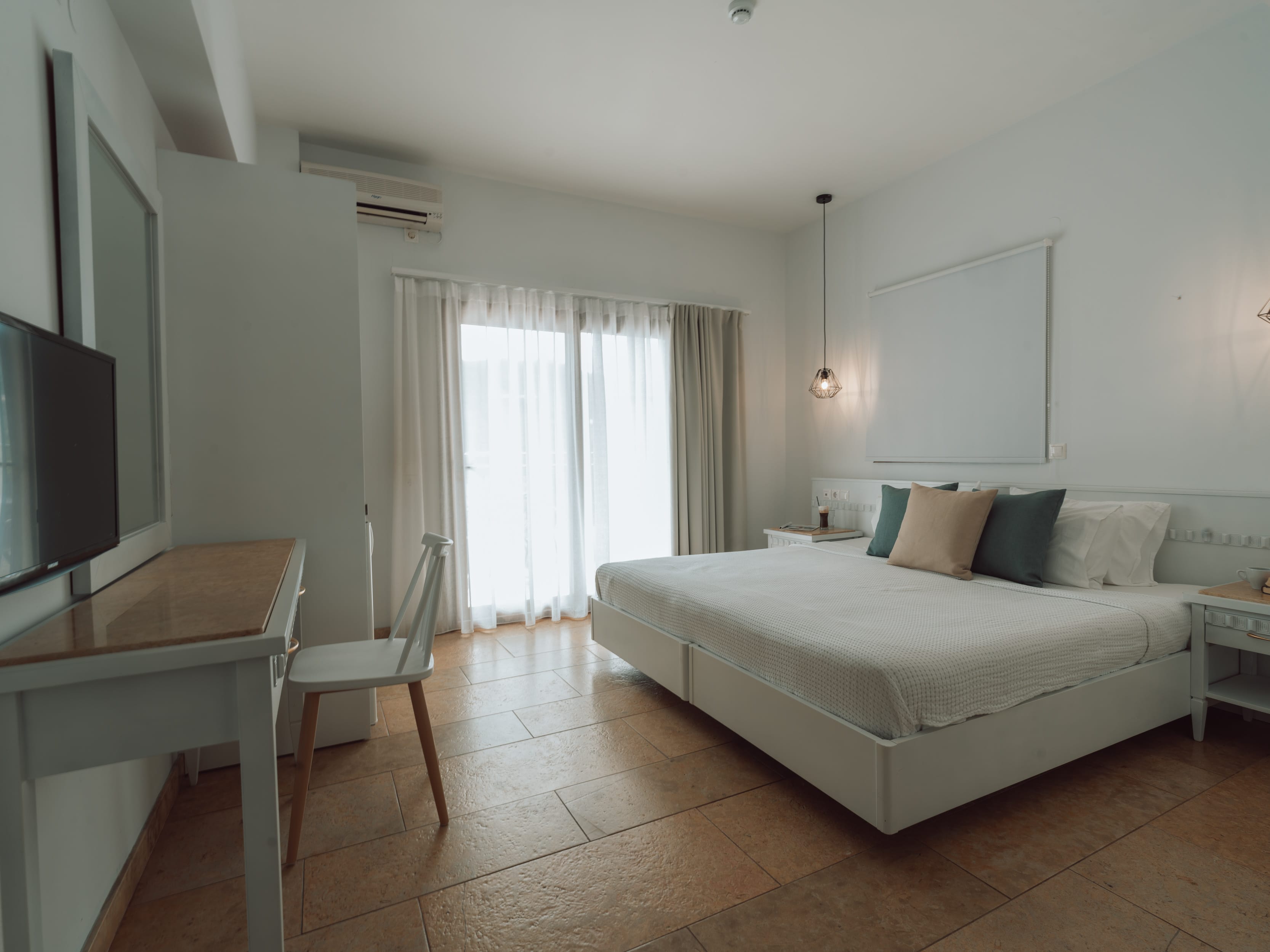 a bedroom with a bed and a desk