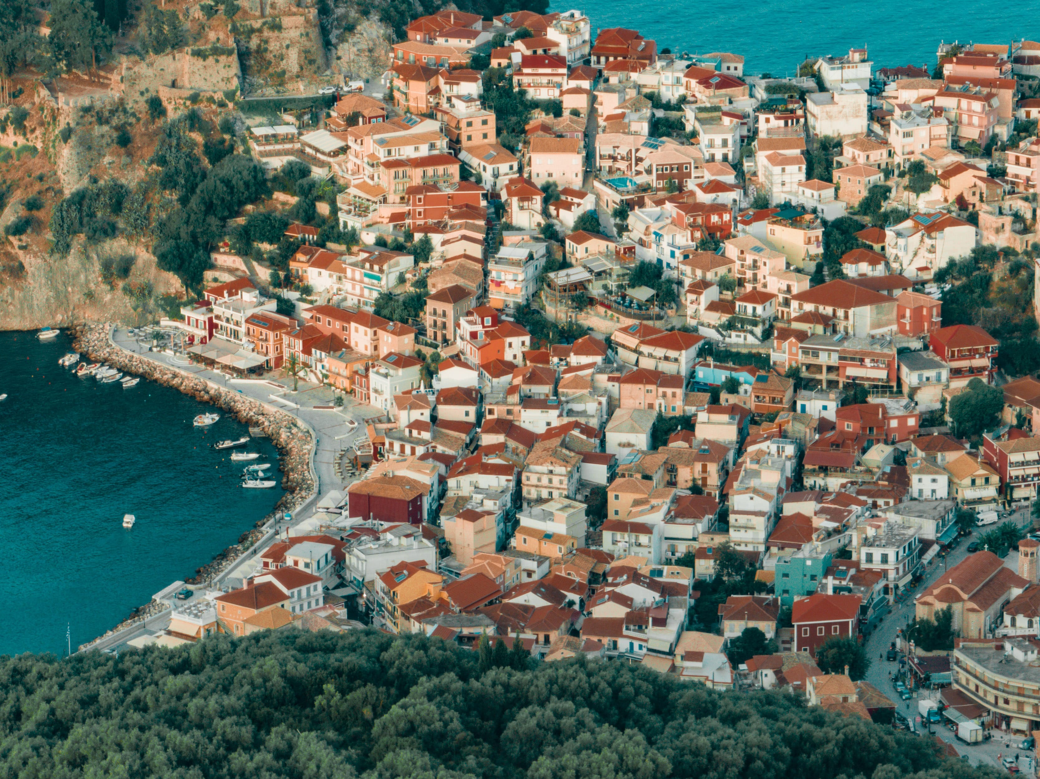 a city with red roofs by the water