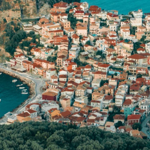 a city with red roofs by the water