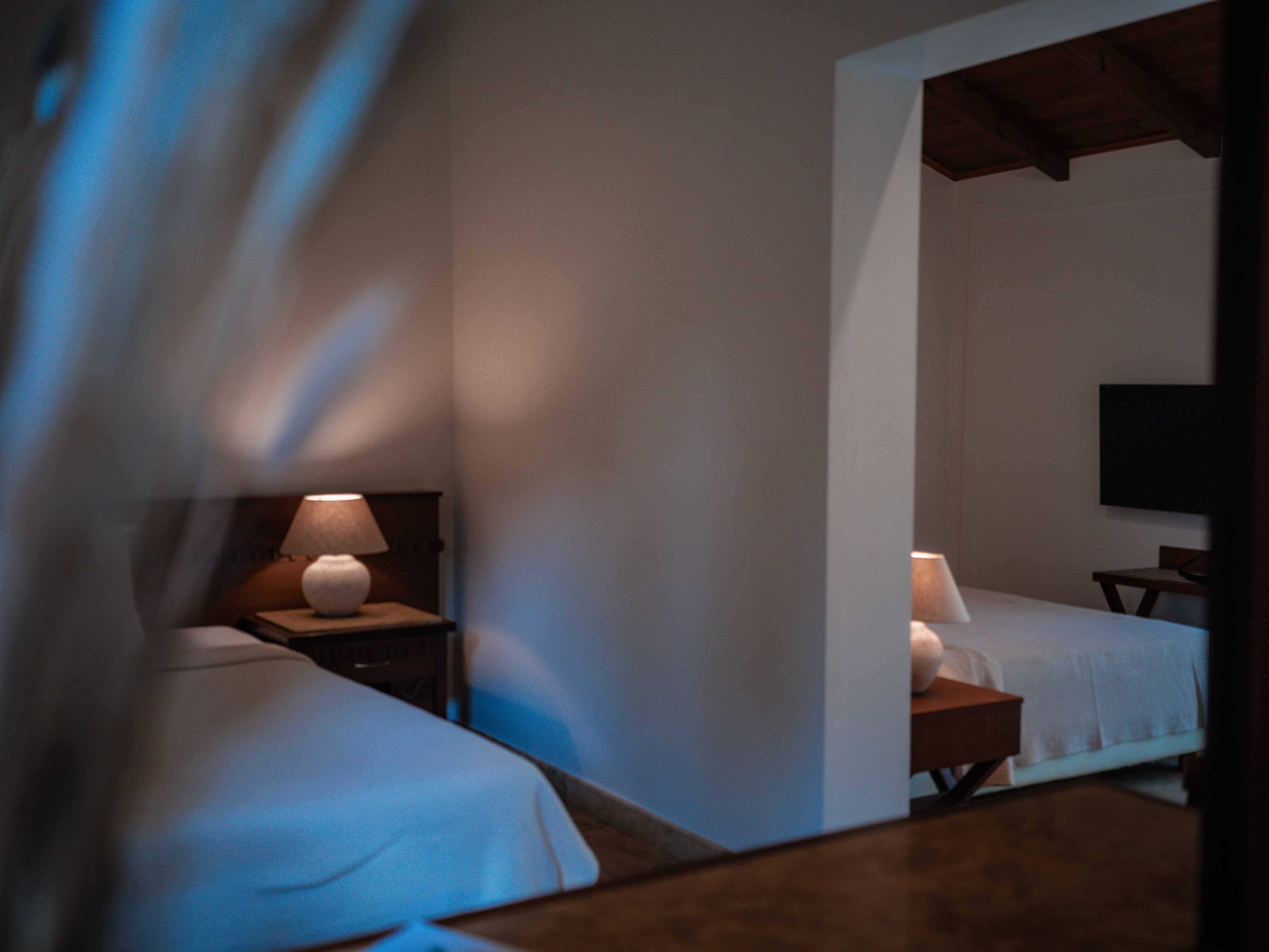 a room with a bed and a lamp