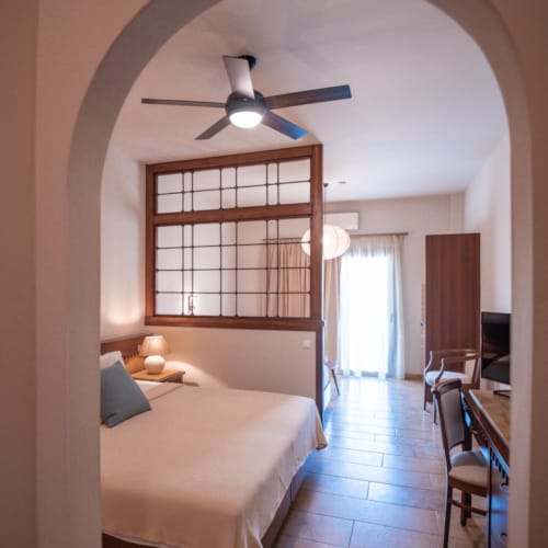 a bedroom with a large window