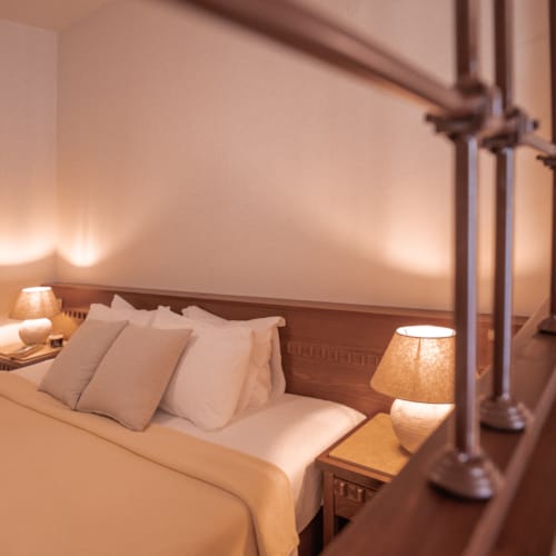 a bed with a lamp on the side