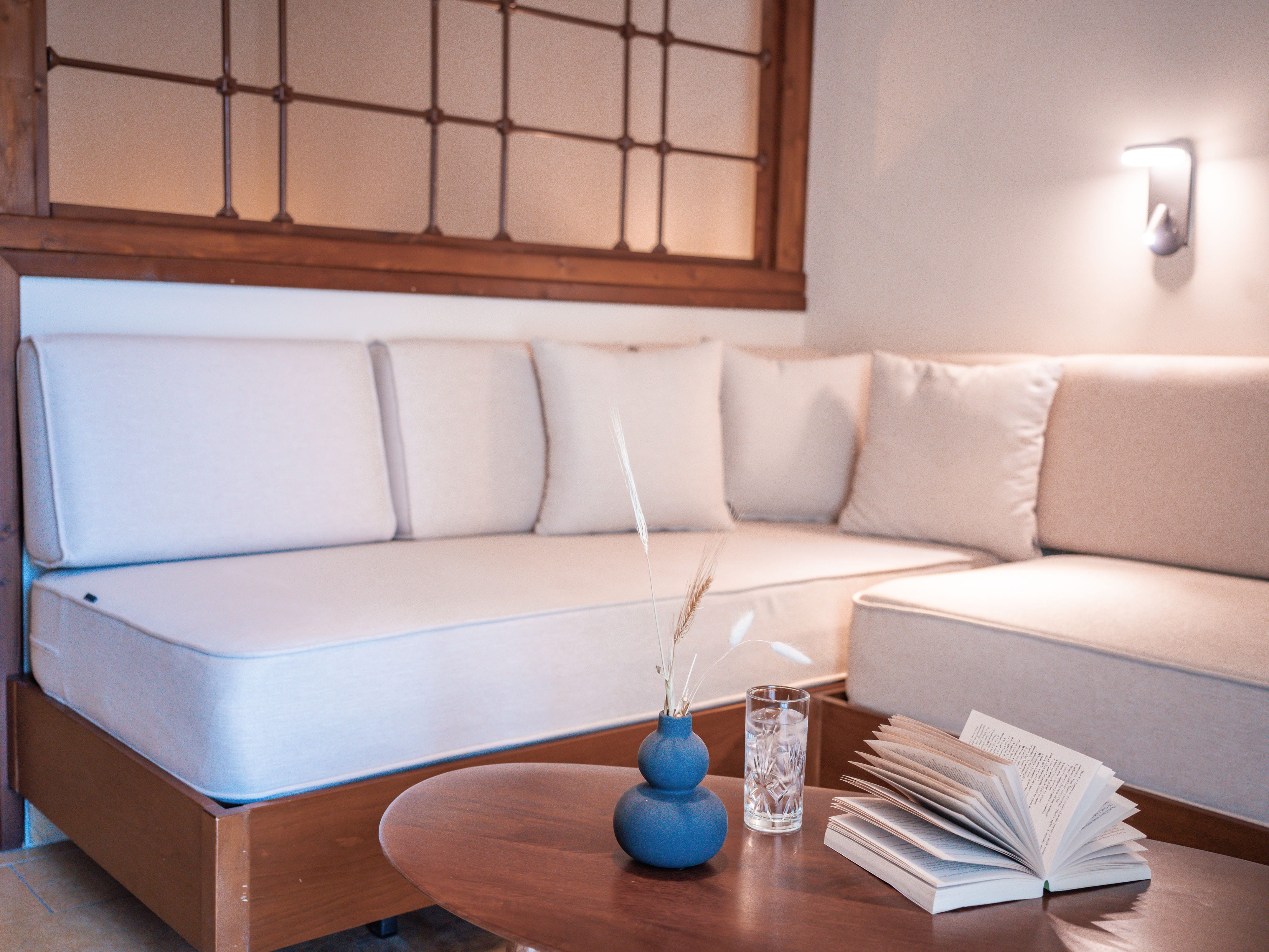 a white couch with a blue vase