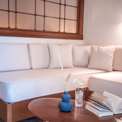 a white couch with a blue vase