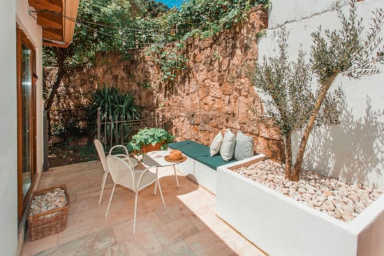 a patio with a table and chairs