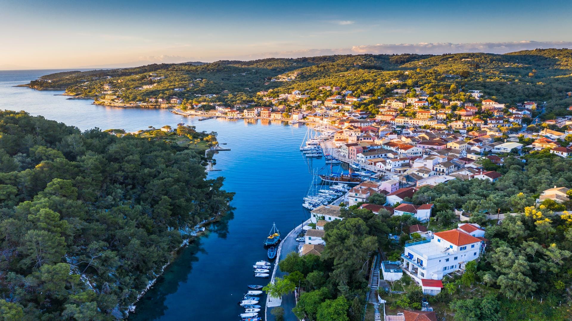 a body of water with buildings and trees around it