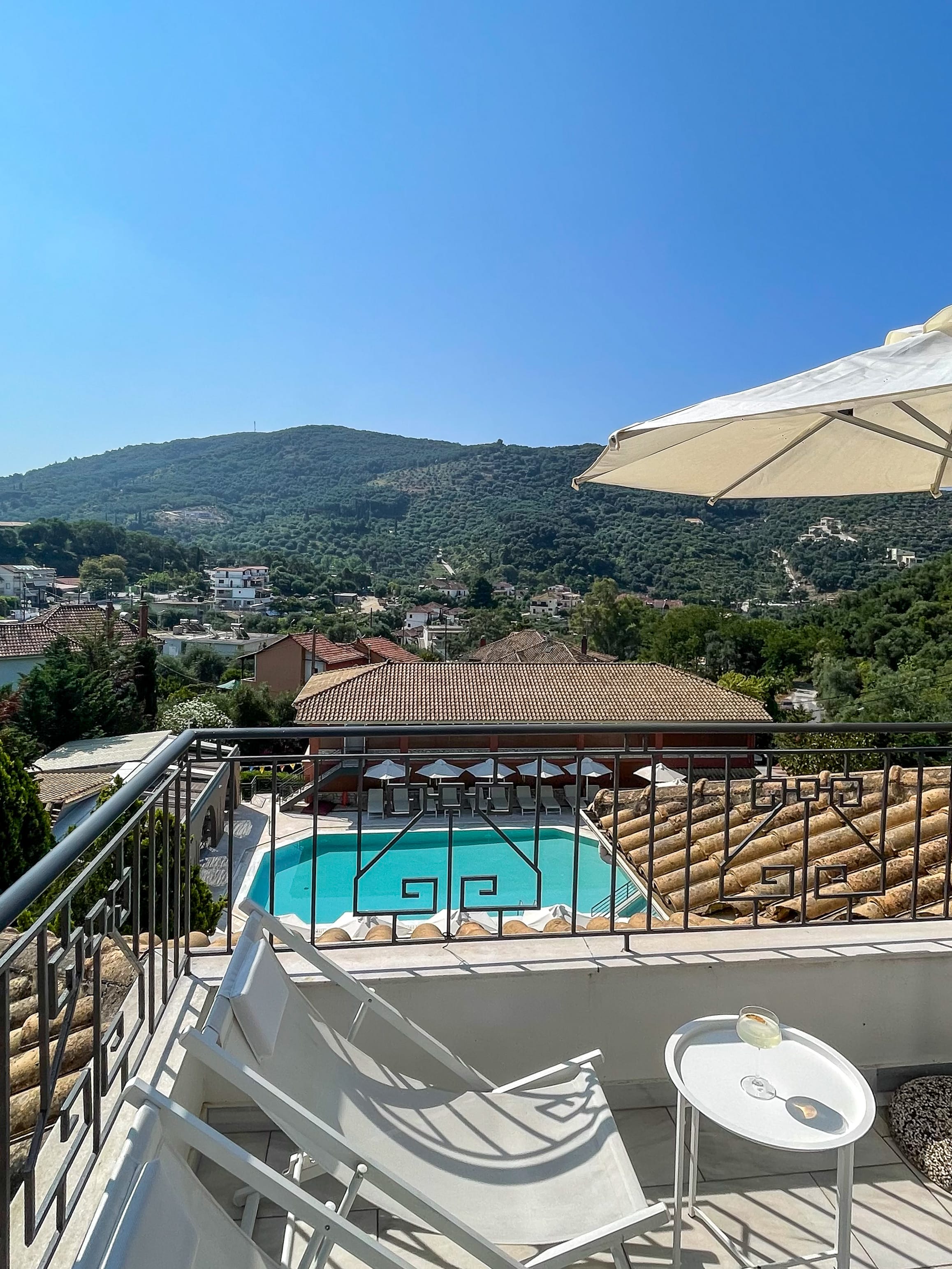 a pool and chair on a balcony