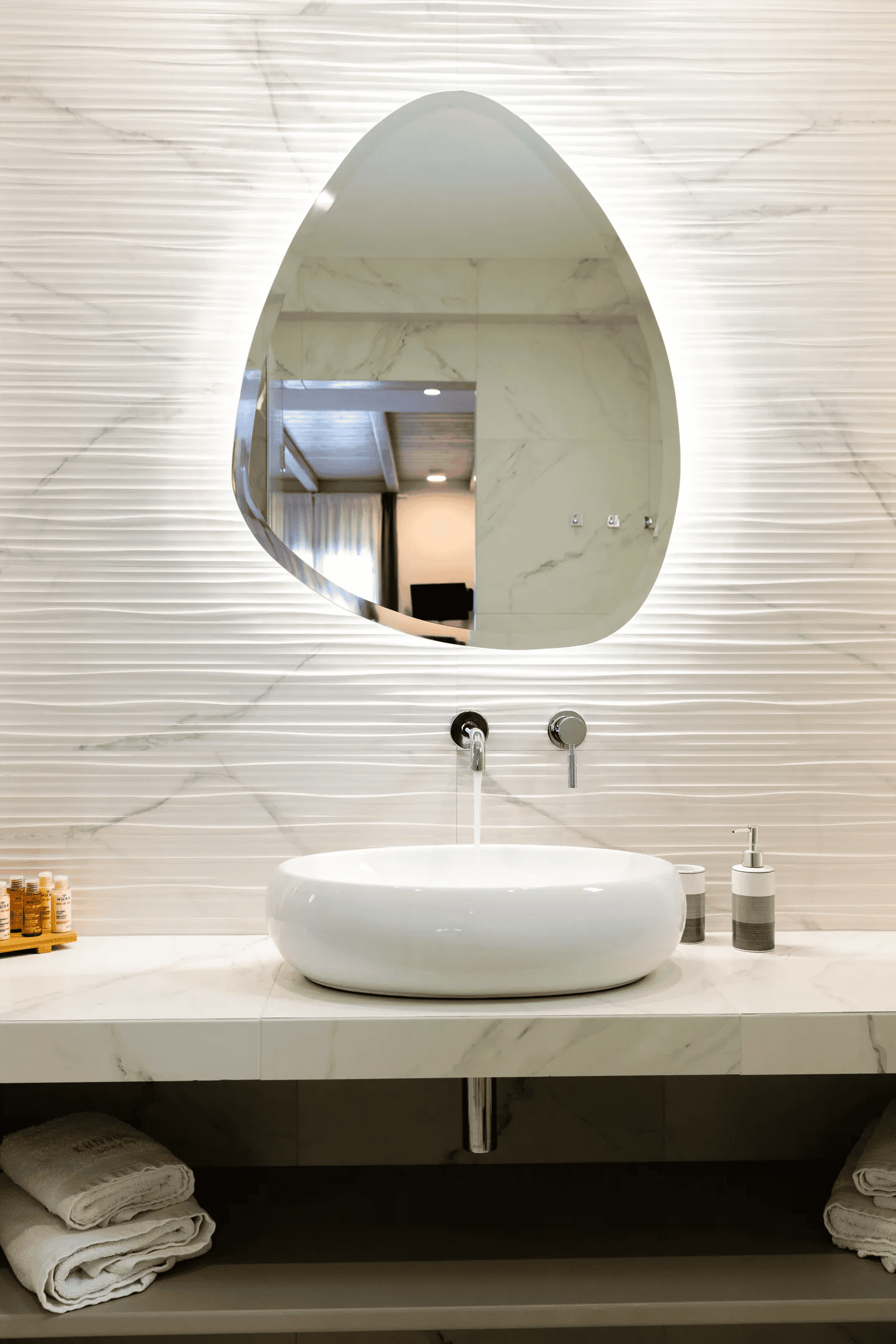 a bathroom with a round mirror