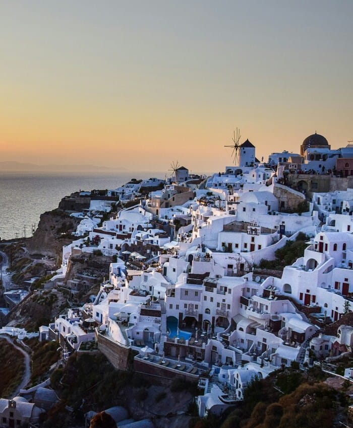 a city with a body of water in the background