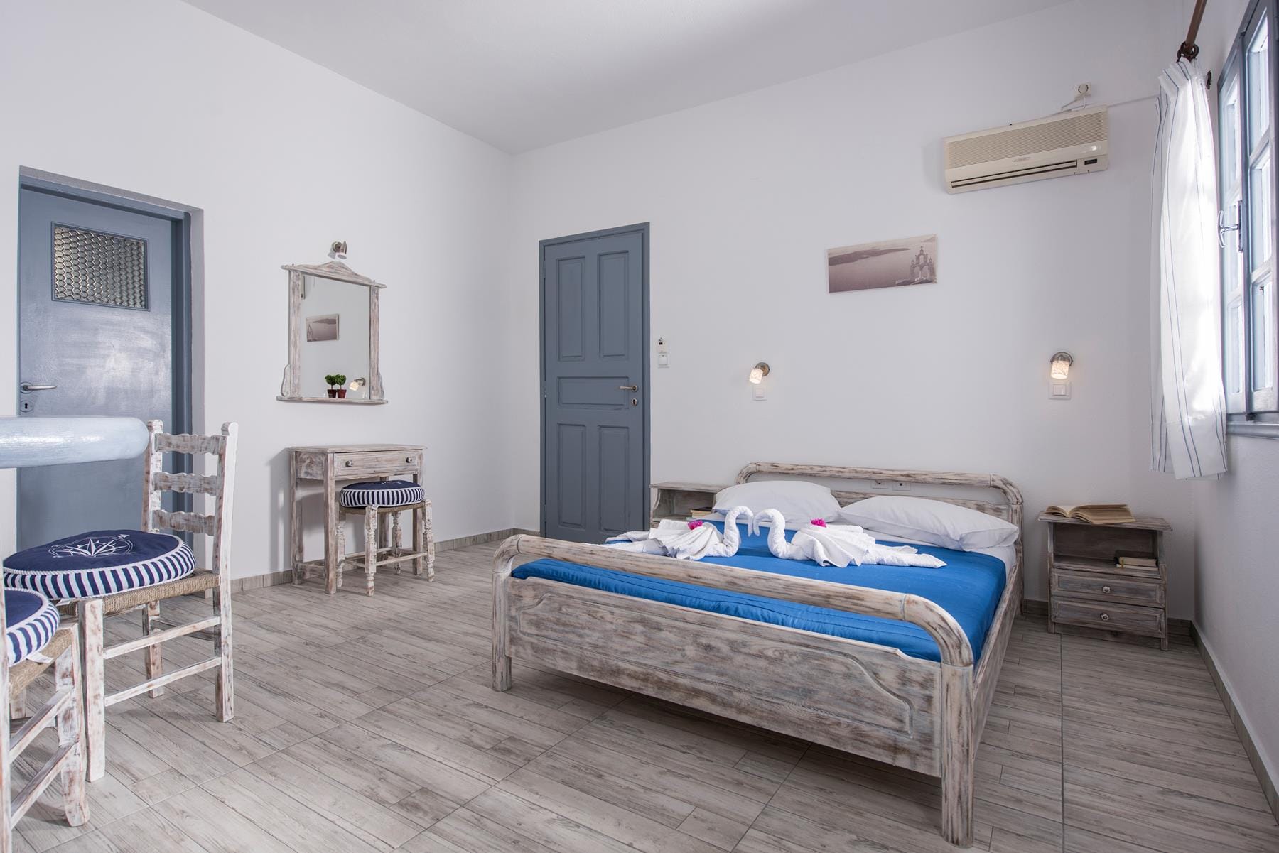 a bedroom with a bed and chairs