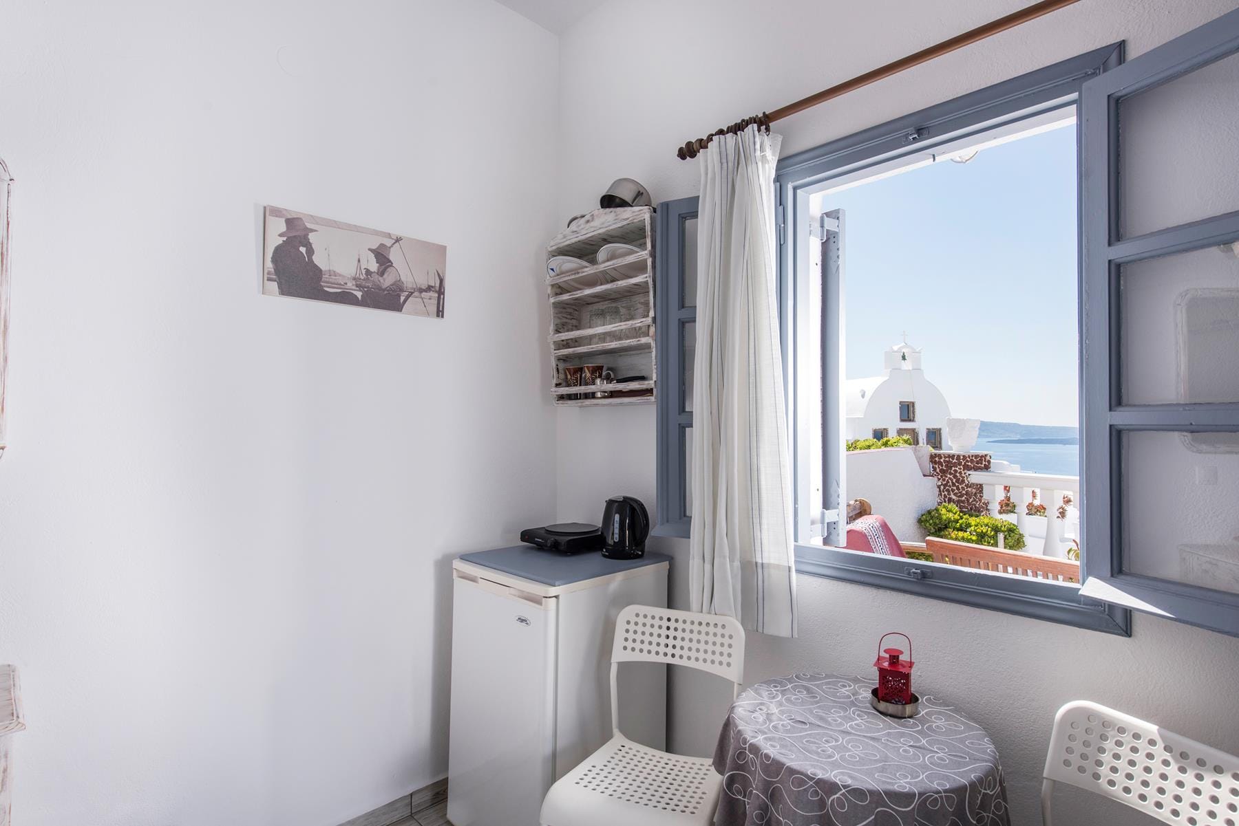 a room with a window and a table with a chair and a table