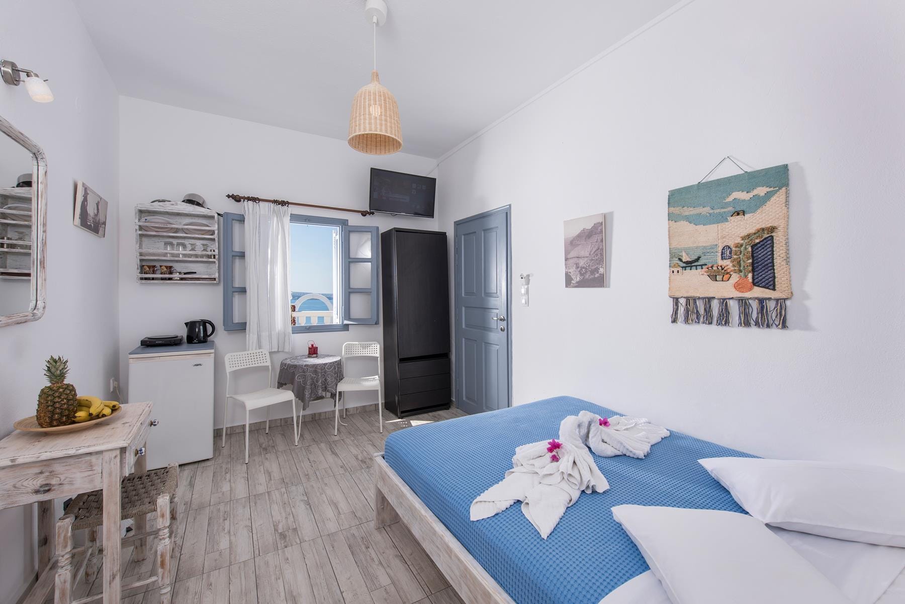 a bedroom with a bed and a tv